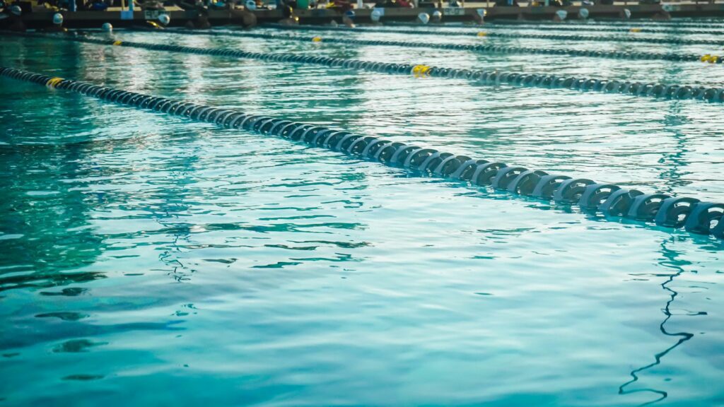 Calm and inviting outdoor swimming pool with blue water and lane dividers.